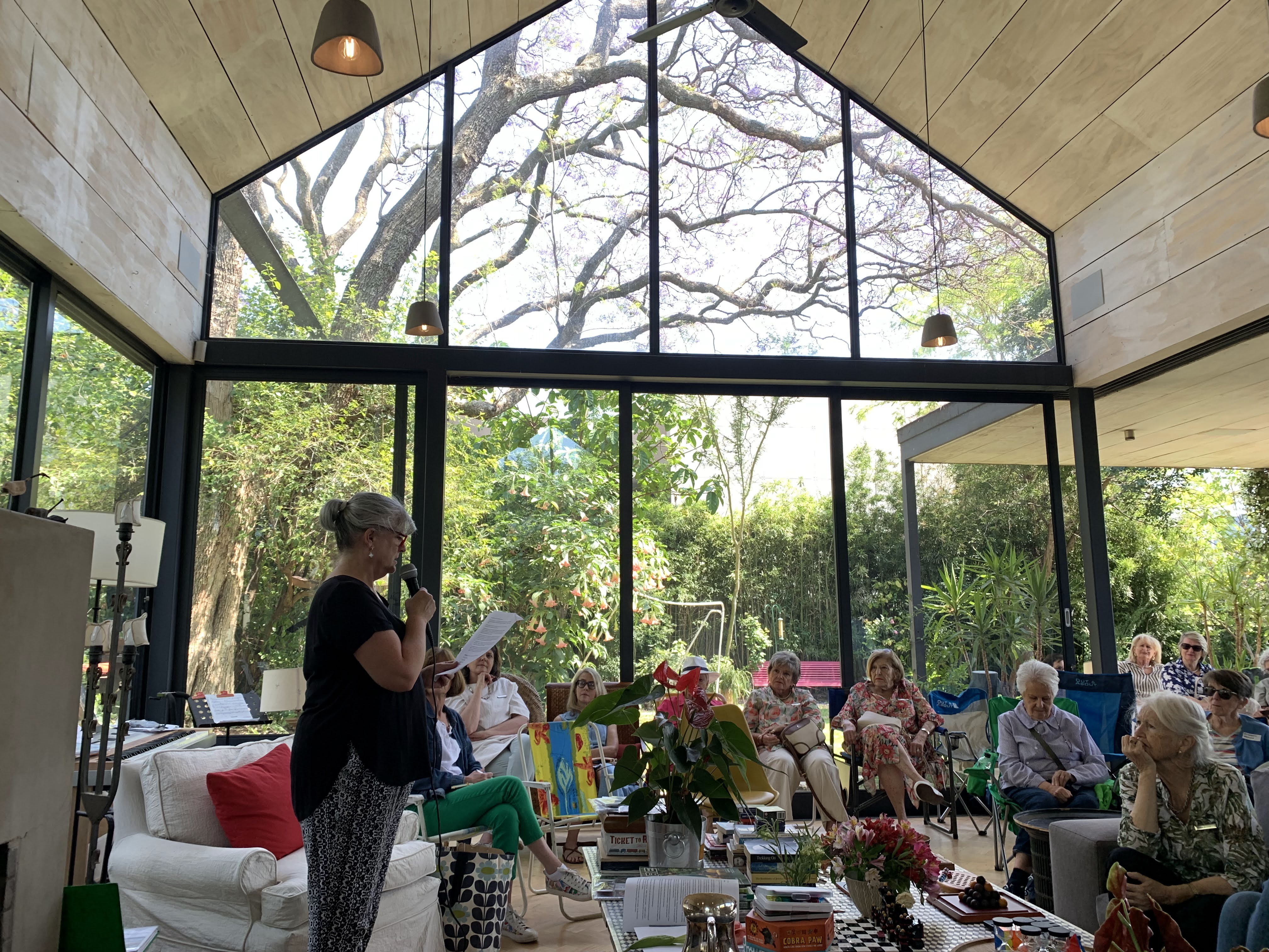 Members gathered in a light-filled garden room